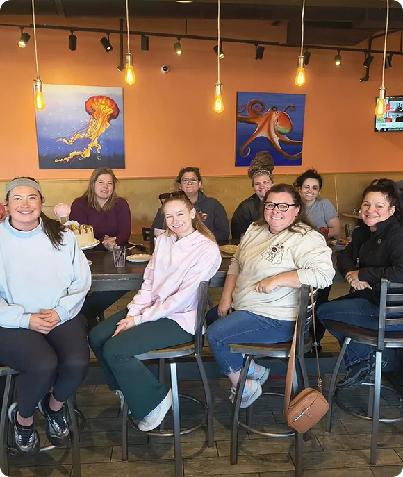 Friends seated in a cozy restaurant setting
